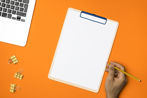Orange background with a clipboard 