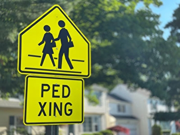 Pedestrian crossing road sign in a neighborhood