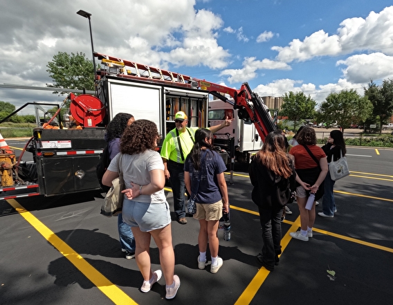 Summer campers looking at a MnDOT vehicle