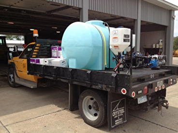 Spraying unit installed on the back of a flatbed truck