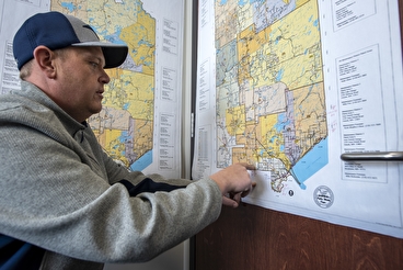 Member of the St. Louis County project team pointing at a map of the system
