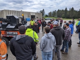 meeting of workers around Stepp Manufacturing construction trailer
