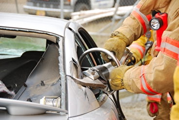 jaws of life device being used to remove steel from car