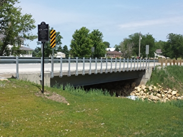 A steel bridge spans a waterway.